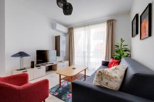 a living room with a couch and two chairs and a table at Charming Central Apartment, Your Perfect Getaway in Msida