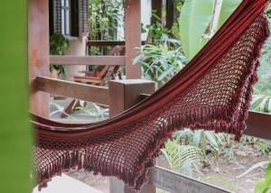 a hammock is hanging from a fence in a garden at Na Villa dos Algodões in Marau