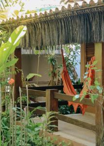 atropical house with a hammock in a garden at Na Villa dos Algodões in Marau