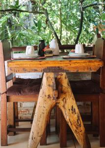 a wooden table with a wooden chair and a wooden table with a wooden table at Na Villa dos Algodões in Marau