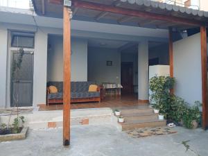 a house with a porch with a couch and a table at Arta room in Durrës