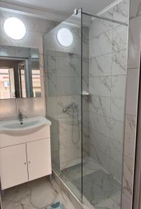 a bathroom with a shower and a sink at Hostel „La Galan” in Rădăuţi +31 photos