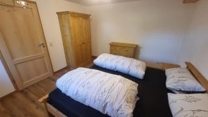 a room with two beds in it with a door at Ruhige Ferienwohnung inklusive Garten Souterrain - neu renoviert in Lachen