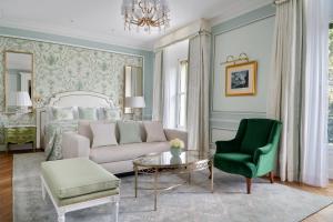 a bedroom with a bed and a couch and a chair at Beau-Rivage Palace in Lausanne +68 photos