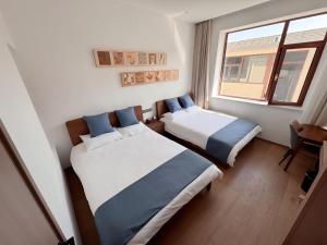 A bed or beds in a room at 蓬莱楠舍清和民宿 蓬莱阁海水浴场店