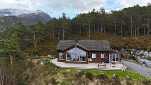 a small house on a hill with a deck at Fjordhytte-13 in Ænes