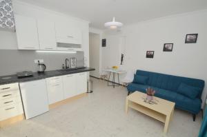 a kitchen and a living room with a couch and a table at Apartments Spasoje in Kotor +30 photos