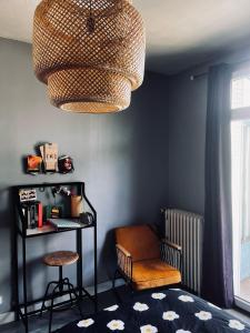 a living room with a chair and a chandelier at Cyrus House in Le Mans +2 photos