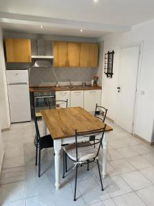 a kitchen with a wooden table and chairs at Bilocale comfort nel centro storico in Livorno