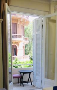 a door open to a patio with a table outside at Crown Hotel royal in Cairo