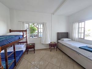 Postel nebo postele na pokoji v ubytování Hostel Chico Lessa
