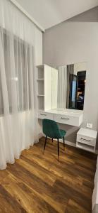 a room with a green chair in front of a mirror at Bahr DELUX App & Suite in Ulcinj