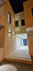 a large empty room with a brick wall at Bahr DELUX App & Suite in Ulcinj