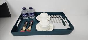a tray with bottles of water and utensils at Bahr DELUX App & Suite in Ulcinj