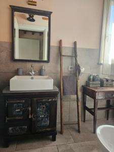 a bathroom with a sink and a mirror on the wall at La Bottega del Maniscalco in Filettole +42 photos