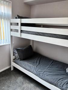 a bunk bed in a room with a bed underneath it at Flat 3 Seaside Haven in Hunstanton