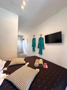 a bedroom with a bed with a flat screen tv at Suíte 7 - Village Capixaba in Gravatá