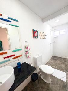 a bathroom with a toilet and a sink and a mirror at Suíte 7 - Village Capixaba in Gravatá +12 photos
