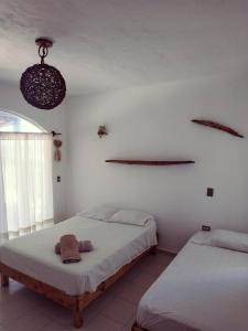 Postel nebo postele na pokoji v ubytování Casa Kayab