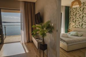 a bedroom with a bed and a view of the water at Apartamenty Boszkowo Horizon Sunrise in Boszkowo