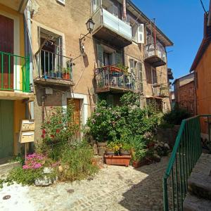 a building with balconies and flowers in a courtyard at apartement des Romains in Sospel +5 photos