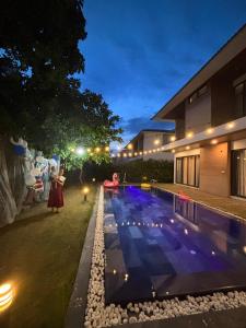 a pool in the yard of a house at night at M Beach Luxury Villas Phu Quoc 2 in Phu Quoc