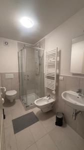 a bathroom with a shower and a sink and a toilet at Duplex in riva al mare in Calambrone +9 photos