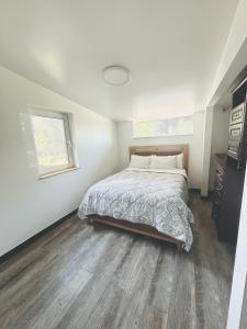 a bedroom with a bed and a wooden floor at Mary s house in Fairbanks