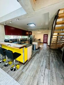 an open kitchen with a yellow counter top and wooden floors at Mary s house in Fairbanks