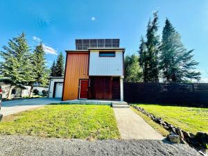 a small house with a red door in a yard at Mary s house in Fairbanks