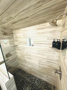 a bathroom with a shower with wooden walls at Mary s house in Fairbanks +16 photos