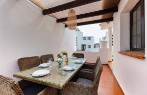 a dining room with a table and chairs at Blue Surf House in Corralejo