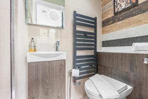 a small bathroom with a toilet and a sink at Contemporary Comfort Steps from Ricoh Arena in Coventry
