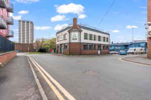 a building sitting on the side of a street at Contemporary Comfort Steps from Ricoh Arena in Coventry