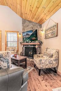 a living room with a fireplace and a couch at Whispering Pines Cabin in Whittier