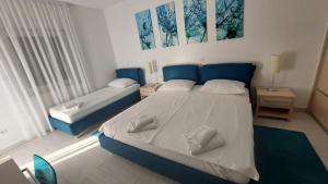 Posteľ alebo postele v izbe v ubytovaní Apartments Villa Alba