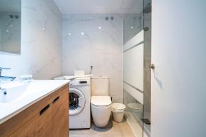 a bathroom with a washing machine and a sink at The Urban Studio Madrid in Madrid +41 photos