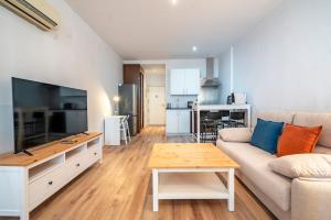 a living room with a couch and a table at The Urban Studio Madrid in Madrid
