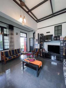 a living room with a couch and a table at Serenity Home Stay in Kandy