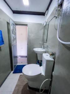a bathroom with a toilet and a sink at Serenity Home Stay in Kandy +24 photos
