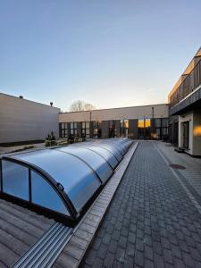 a large building with a long escalator in front of it at Palanga Studio Apartment with a Pool in Palanga