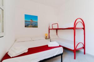 a bedroom with two bunk beds in a room at Villino Airone in Torre Lapillo