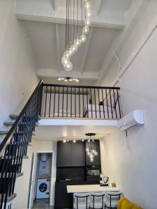 a kitchen with a staircase and a table and chairs at Palanga Studio Apartment with a Pool in Palanga