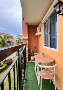 a balcony with a table and chairs and the ocean at The Sos Staycation in Davao City