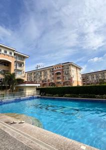 a swimming pool in front of some apartment buildings at The Sos Staycation in Davao City