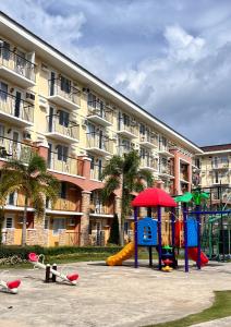 a playground in front of a large apartment building at The Sos Staycation in Davao City
