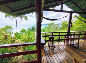 a wooden deck with a table and a bench on it at Corcovado Air in Drake +14 photos