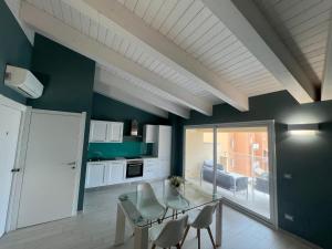 a kitchen with a table and chairs in a room at R & D in Alghero