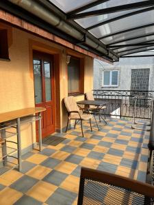 a patio with a table and chairs on a floor at Car-es panzió in Veľký Meder +26 photos