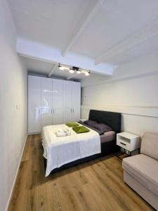 a bedroom with a large bed and a couch at Palanga Studio Apartment with a Pool in Palanga
